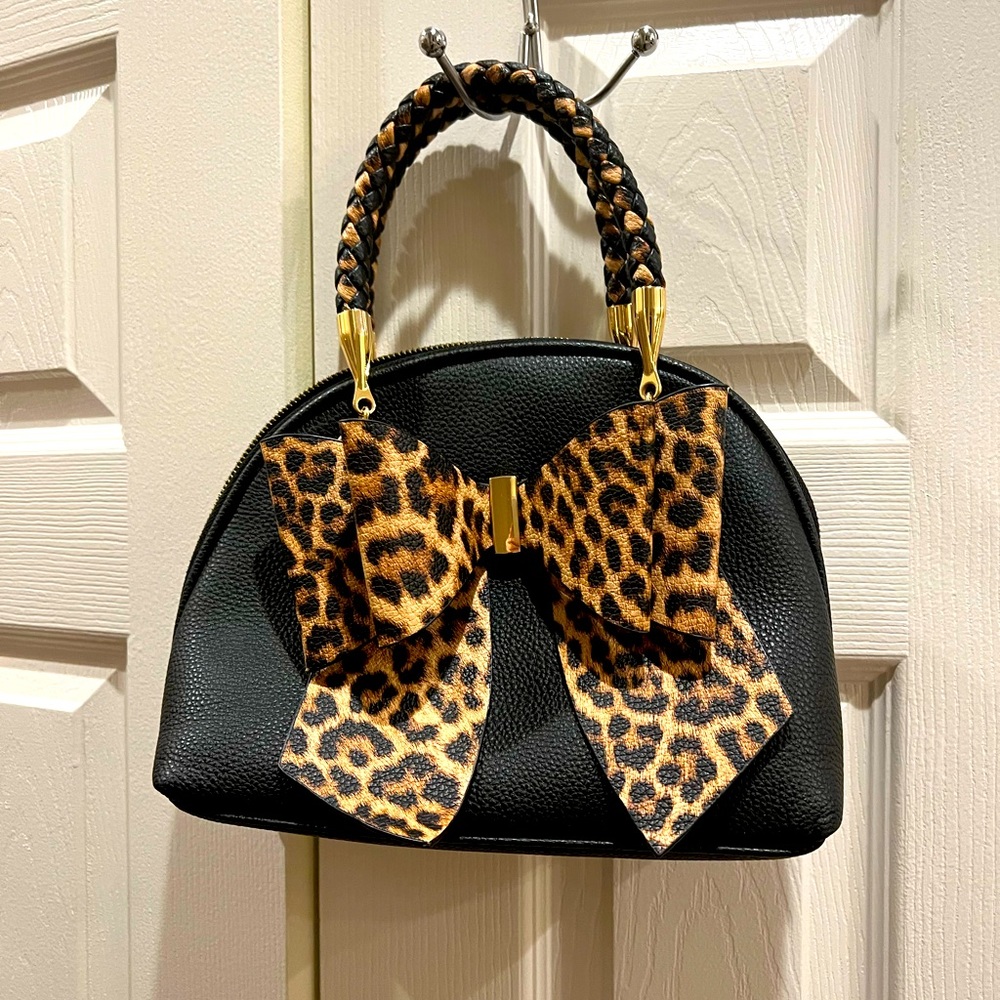 Crossi black purse with leopard bow. In good condition!